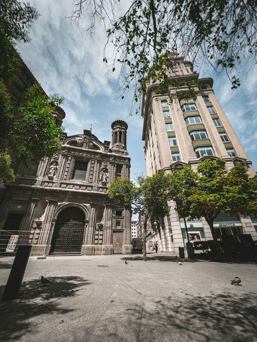 un edificio con árboles y una pasarela