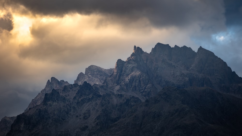 a rocky mountain with clouds