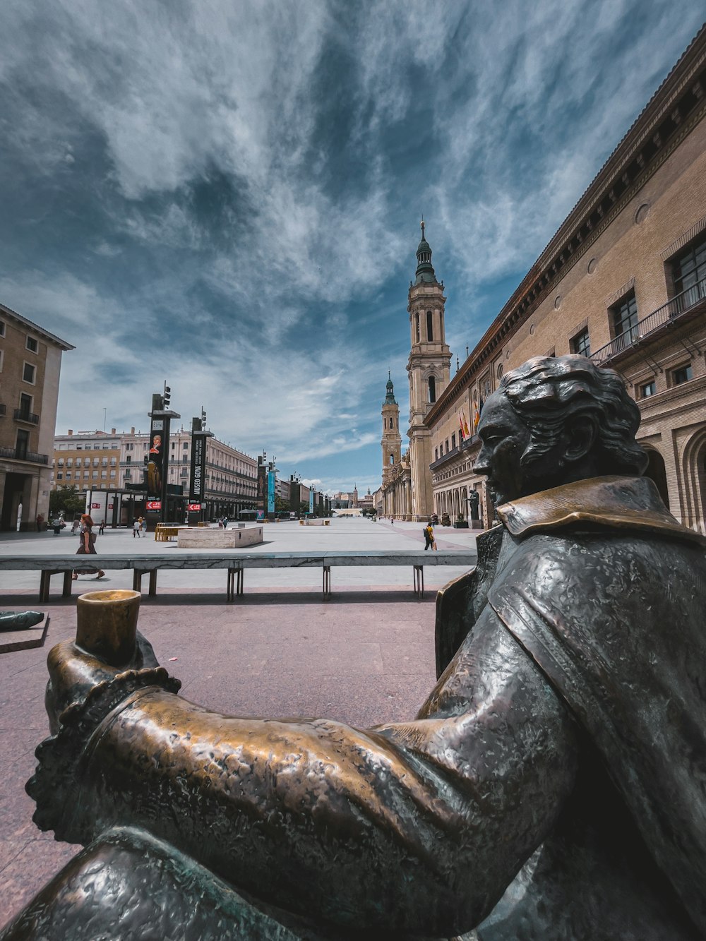 Una estatua de una persona con sombrero y barba en una calle de la ciudad