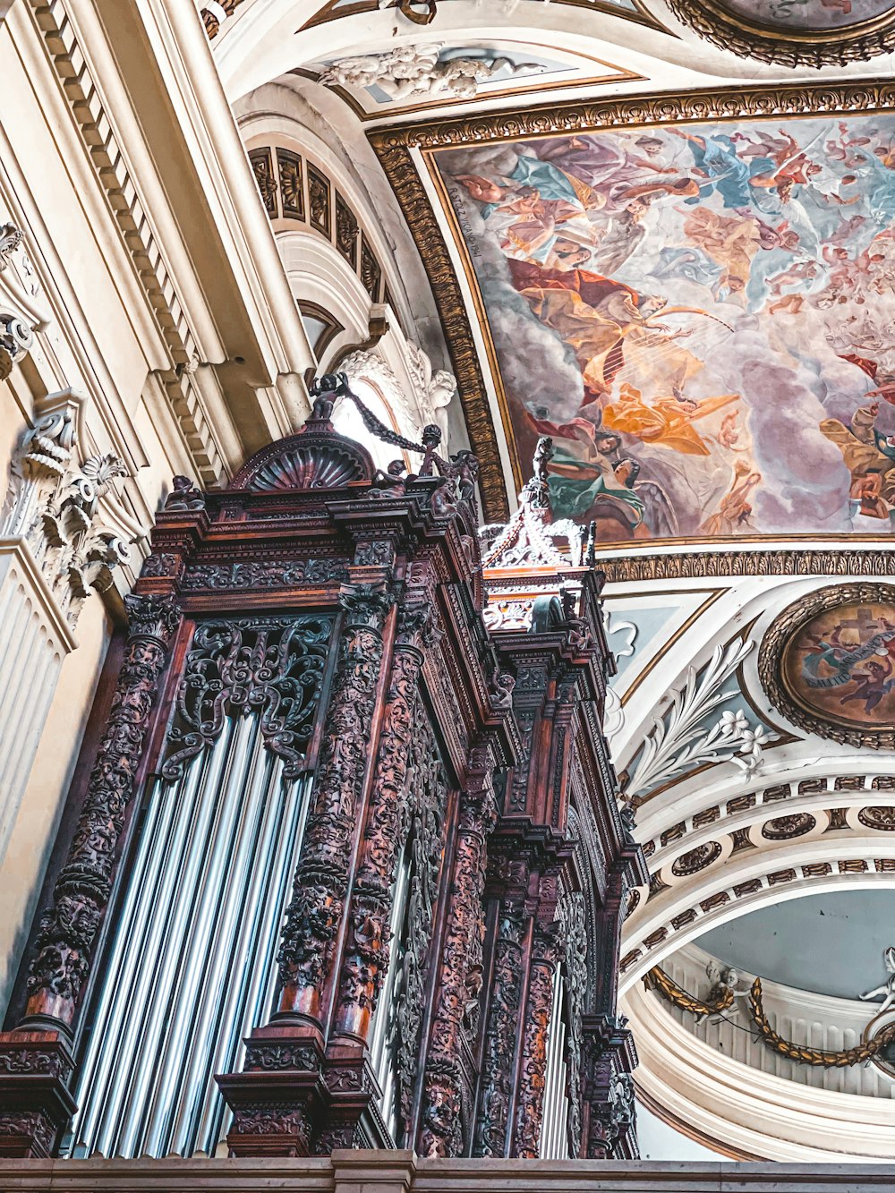 a large ornate ceiling with stained glass windows