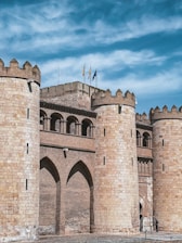 a stone castle with flags on top