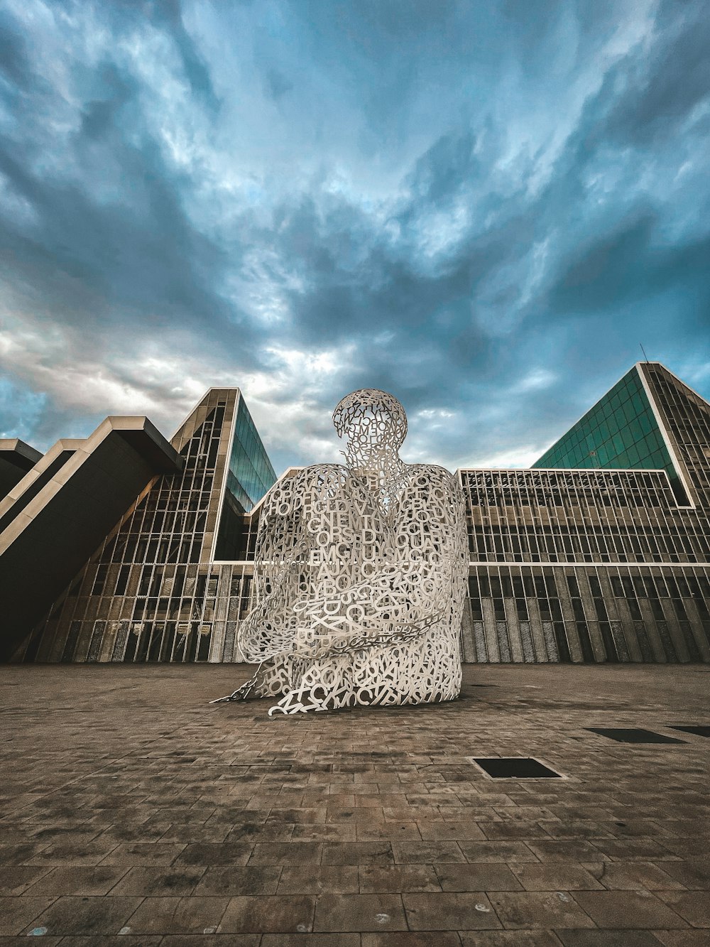 a stone statue in front of a building