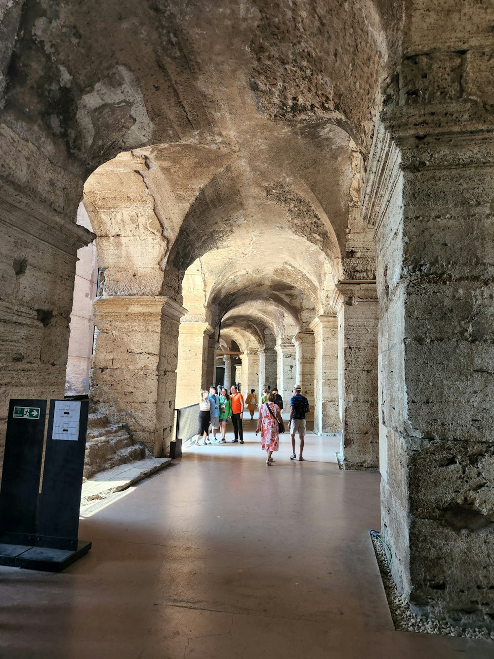 a group of people walking through an old building