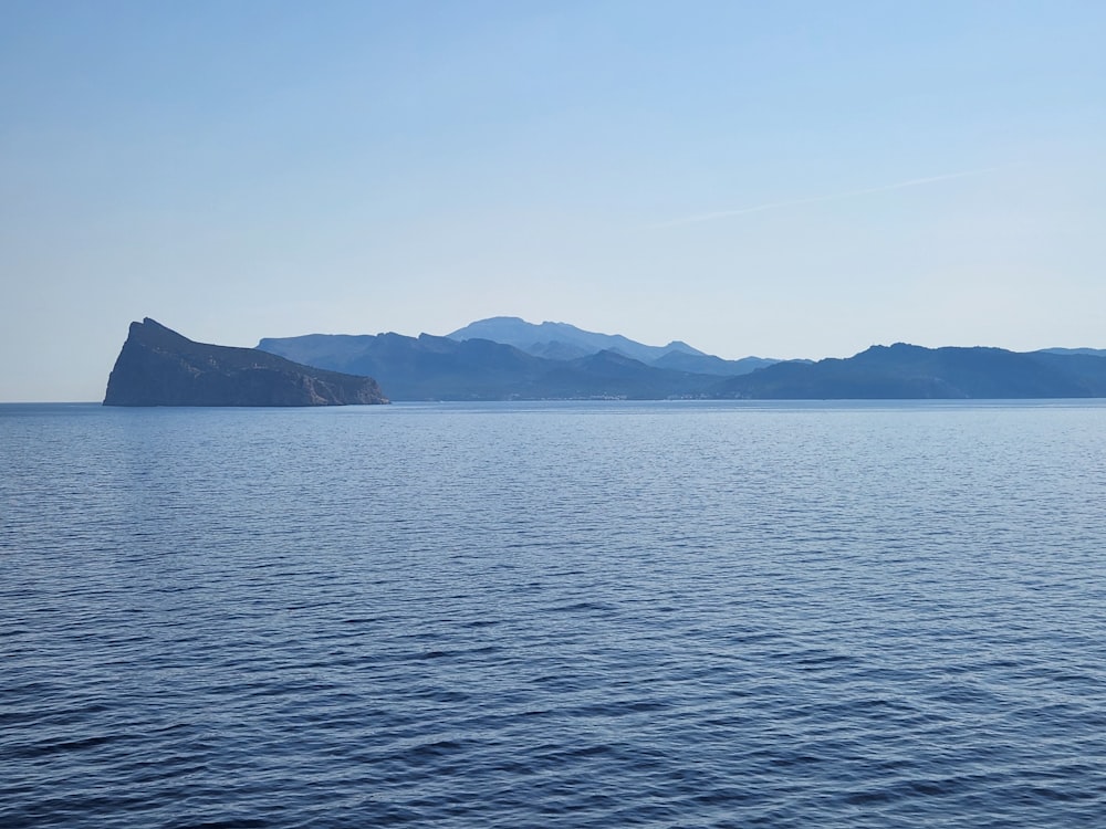 a body of water with mountains in the background