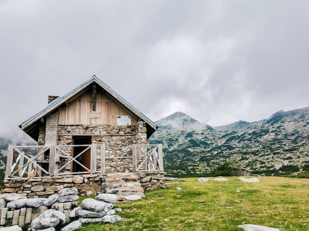 a wooden house in a grassy field