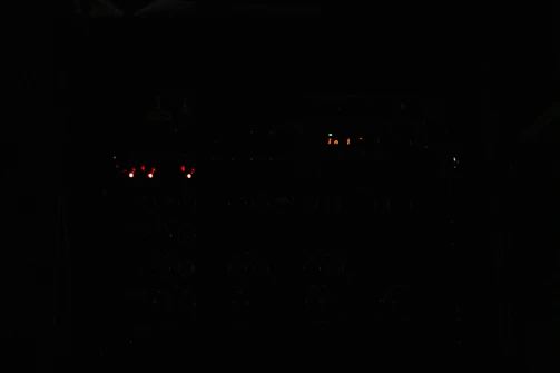 Technicians inspecting nuclear plant equipment under dramatic lighting