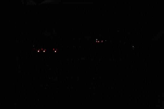 Operational scene with EOD specialists coordinating with robotic units under low light conditions.