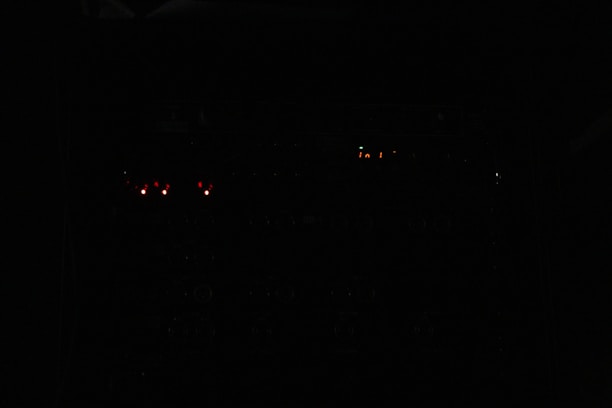 A dark, cinematic scene of soldiers coordinating a mission under orange neon lights.