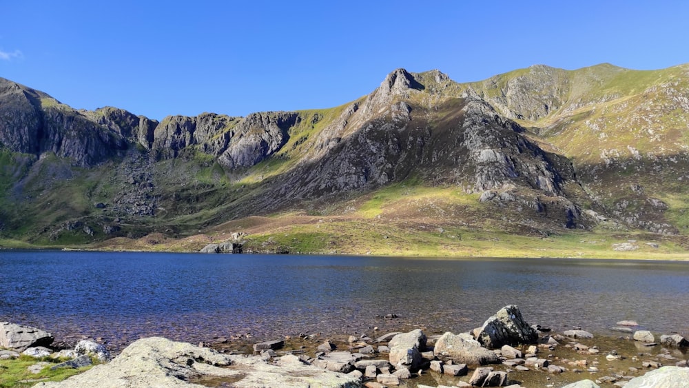 a body of water with mountains in the background