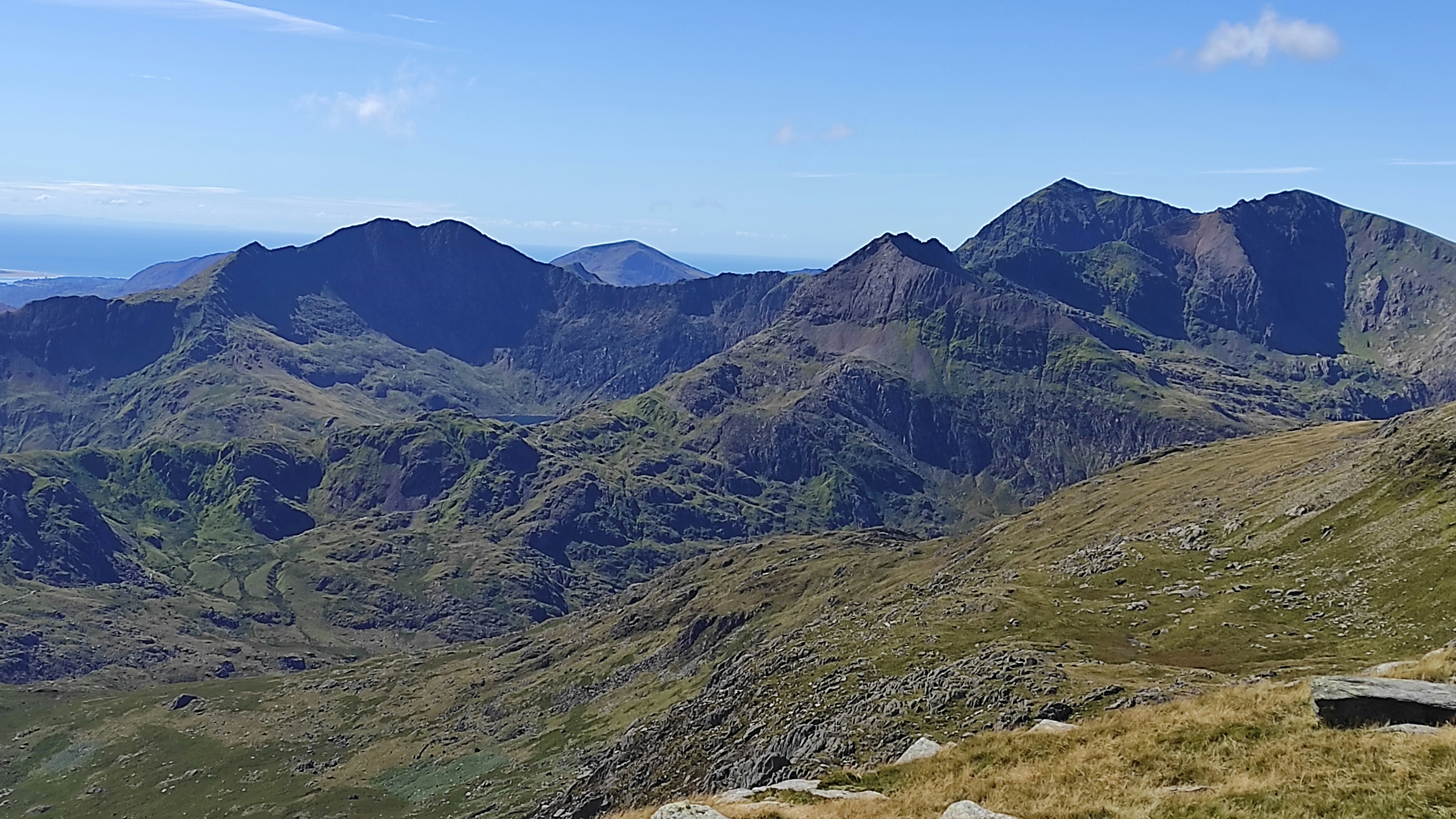 a grassy valley with mountains in the background, 