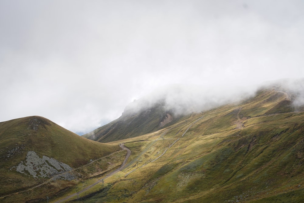 a foggy valley with a road