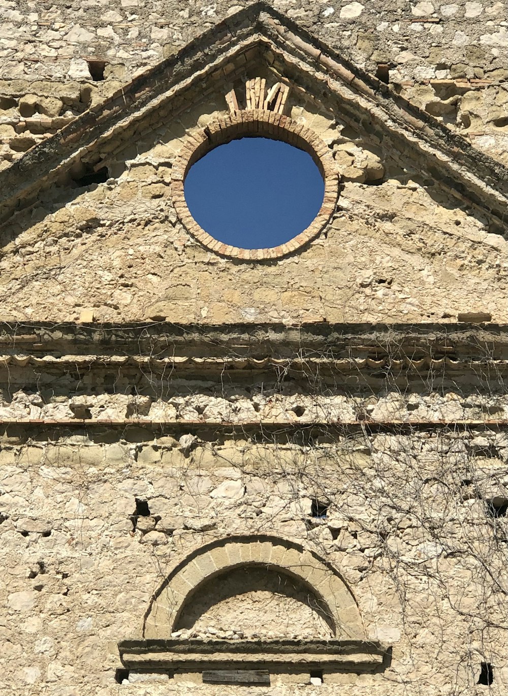 a stone building with a large arched window