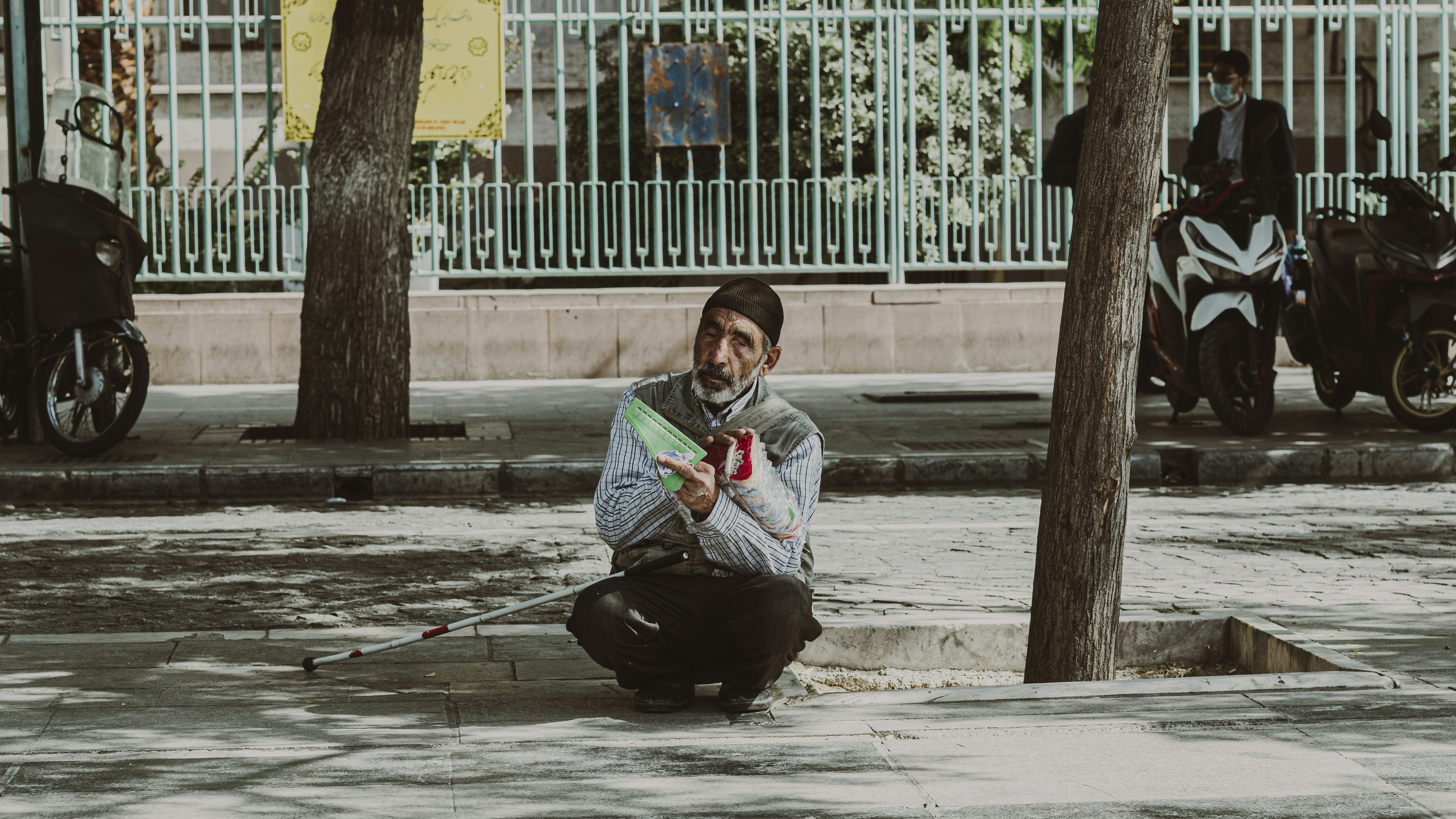 a person sitting on the sidewalk
