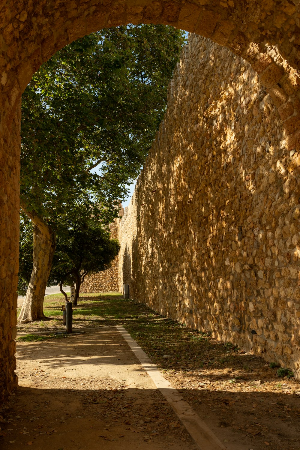 a stone archway with trees