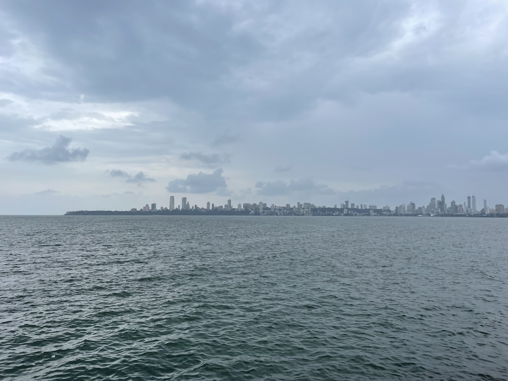 a body of water with a city in the background