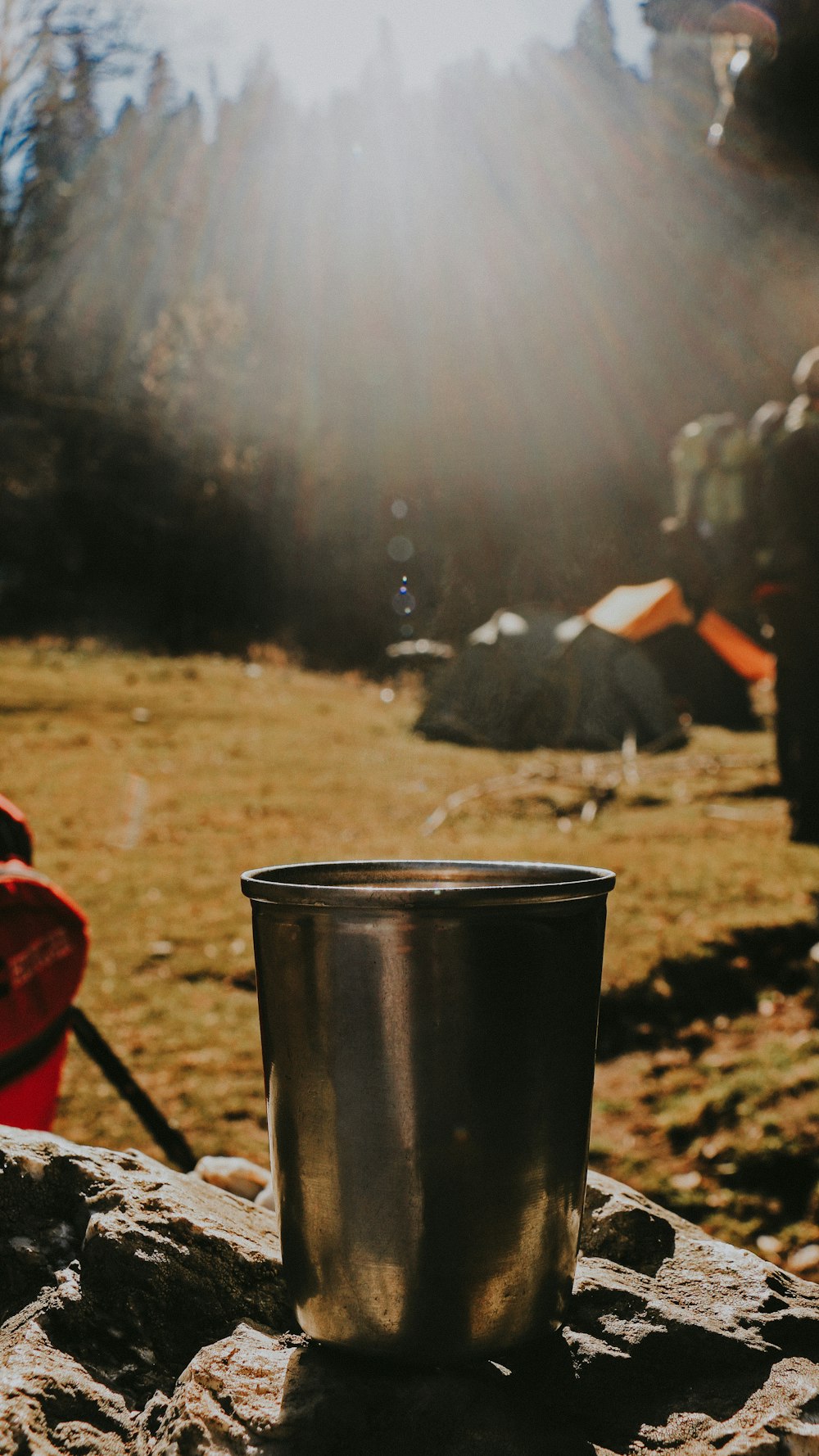 a black cup on a rock