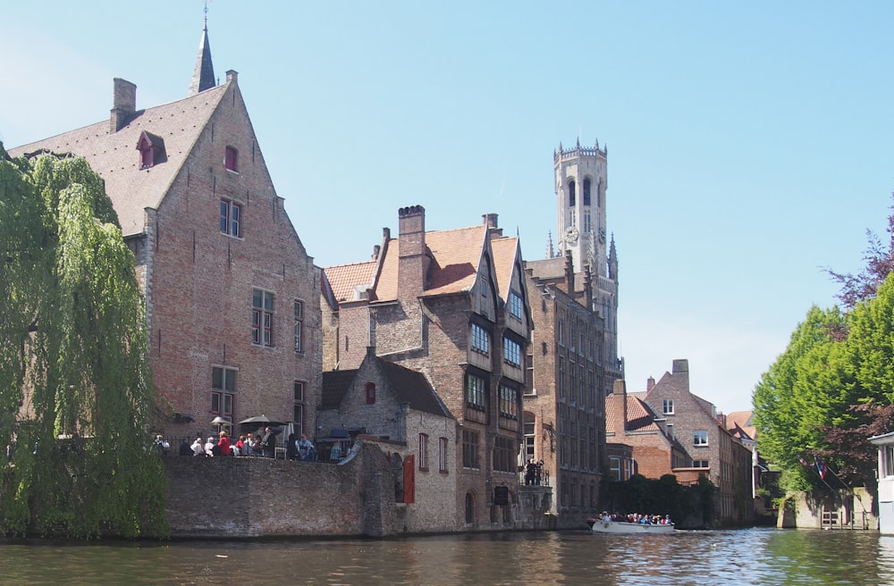 a group of buildings next to a body of water with Bruges in the background