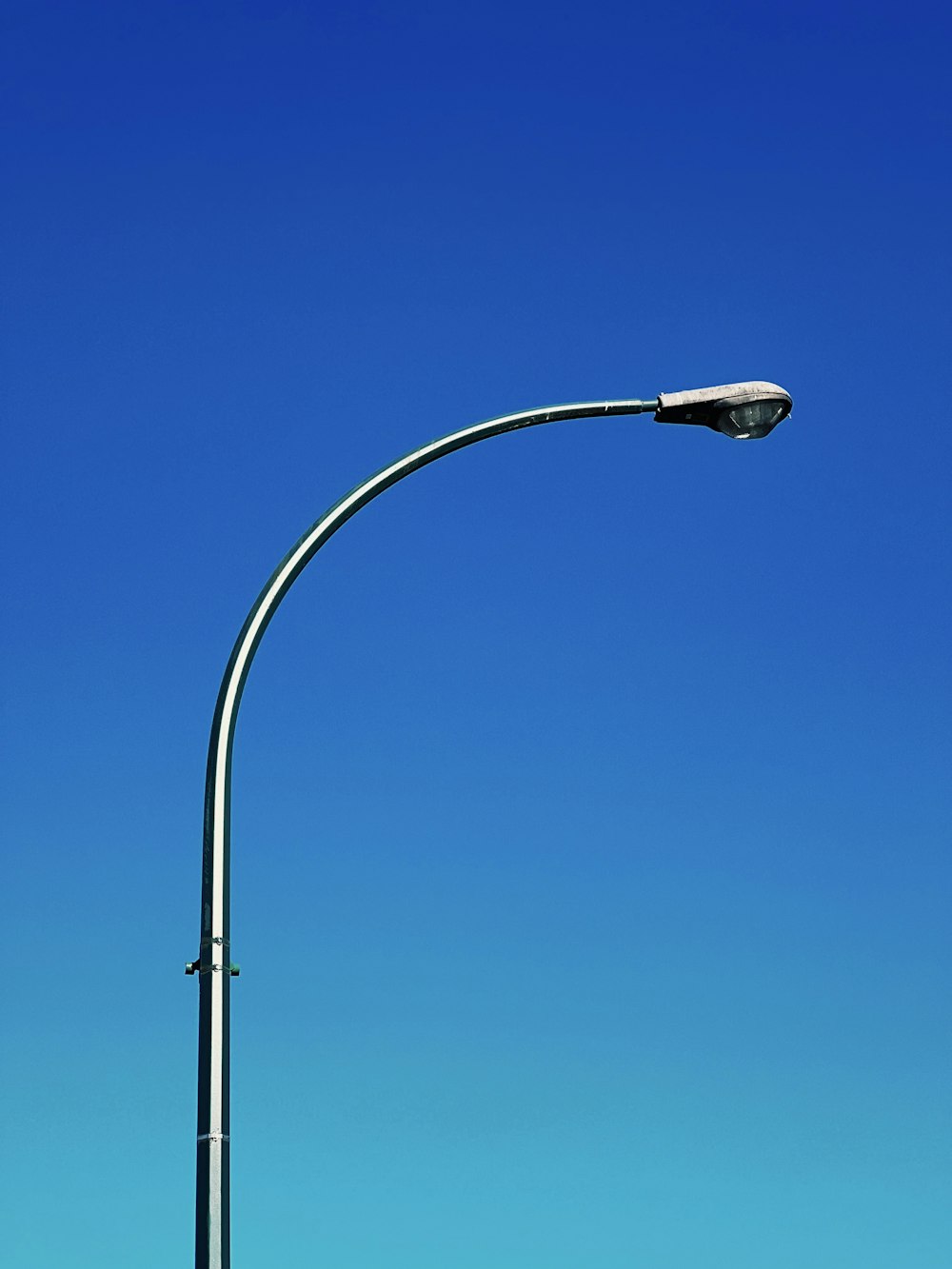 a street light against a blue sky