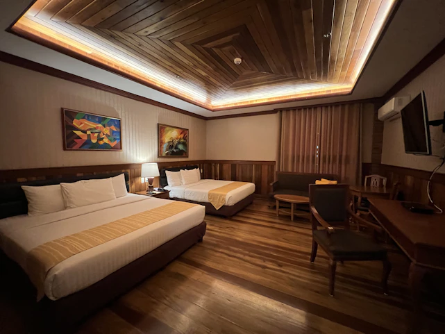 a hotel room with a bed and desk