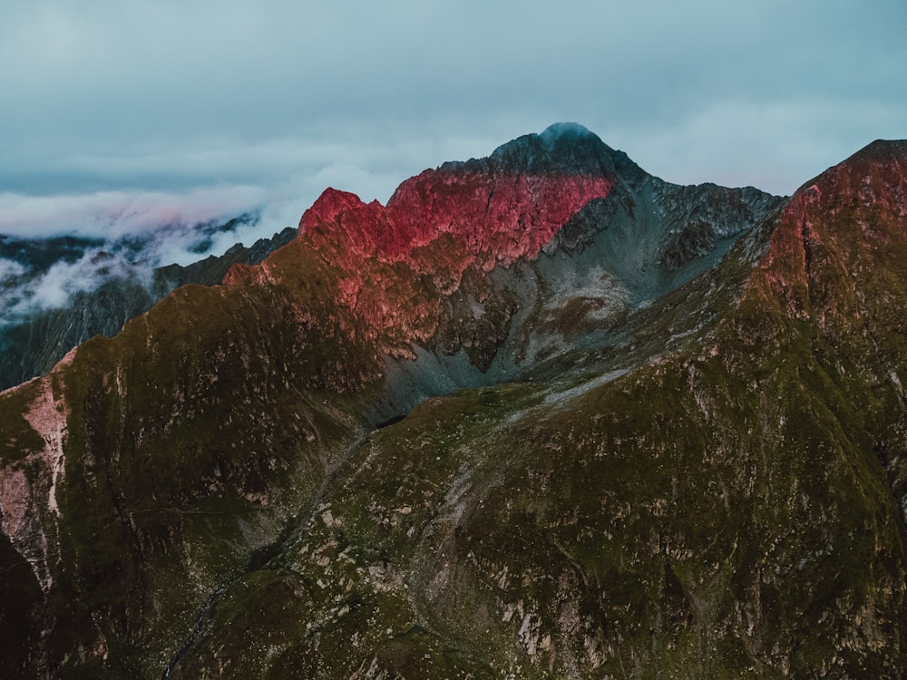 a mountain with a red peak