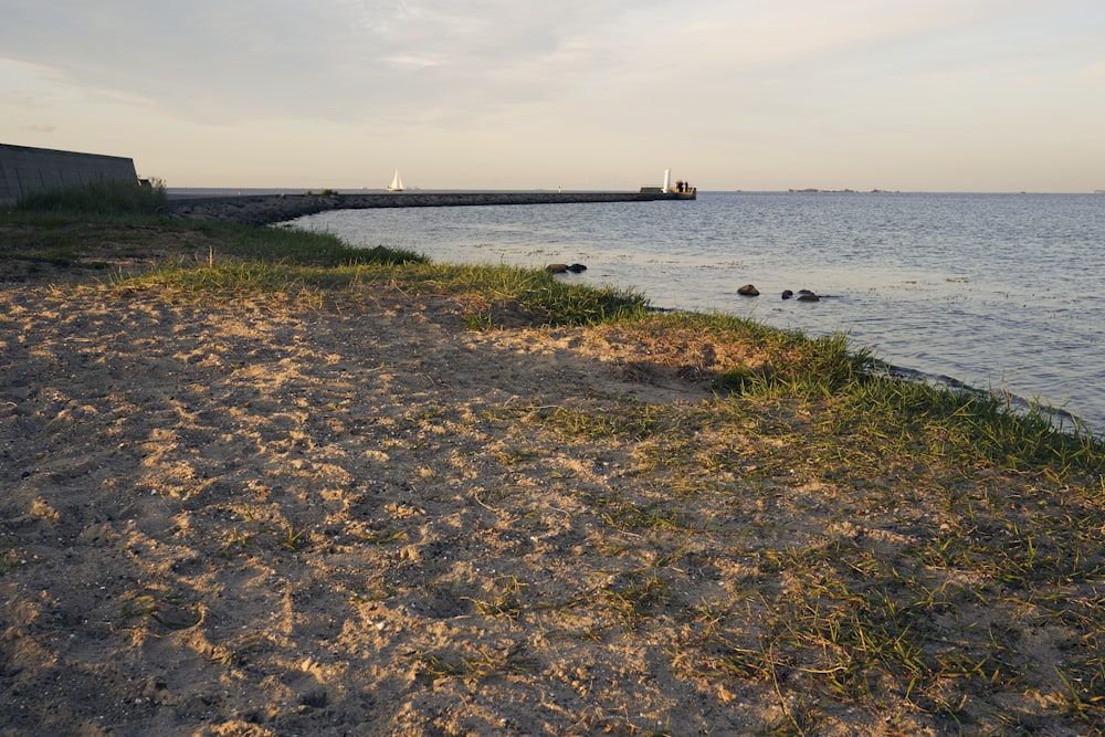 a rocky beach with a boat in the distance