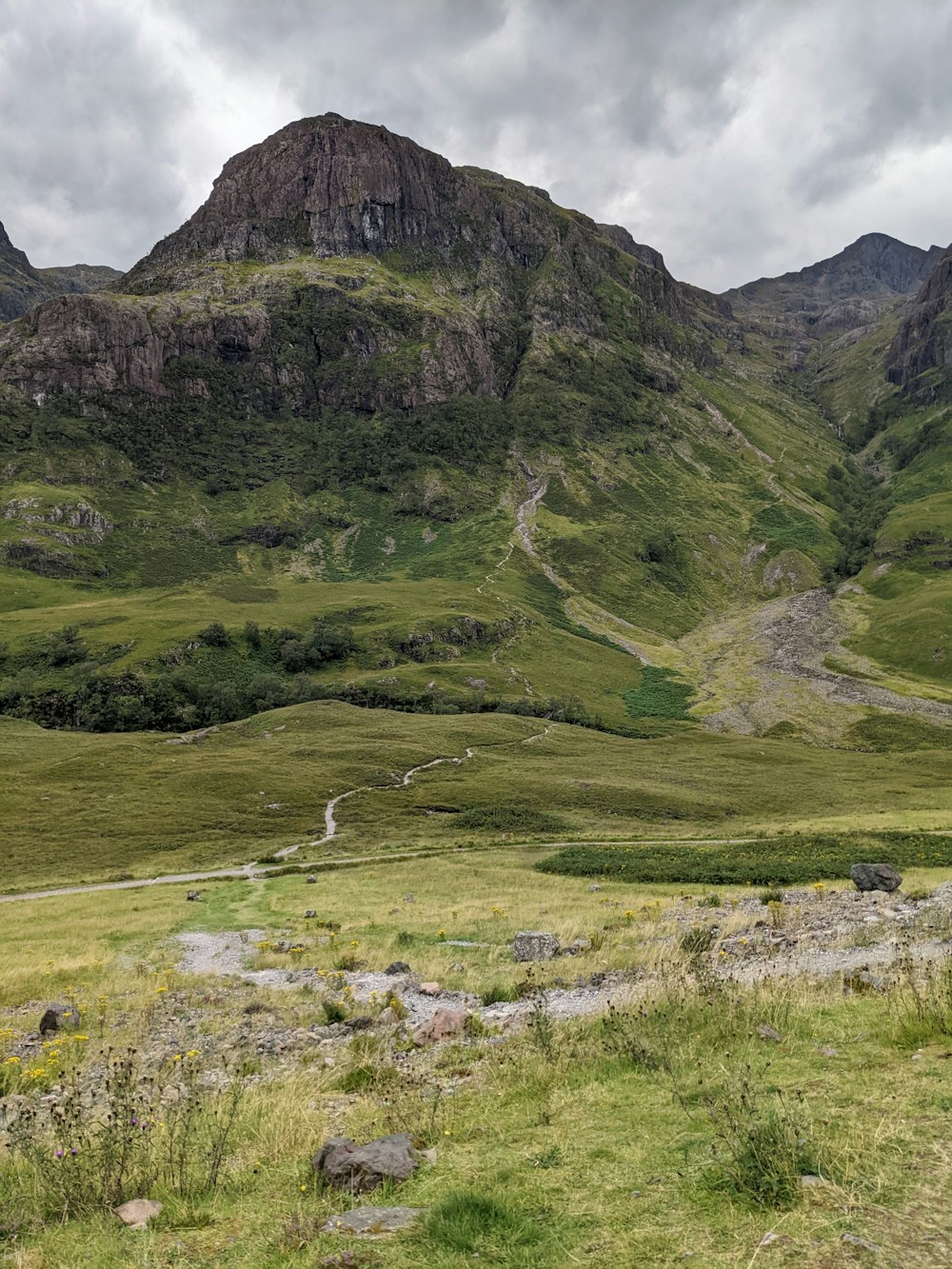 a mountain with a stream running through it