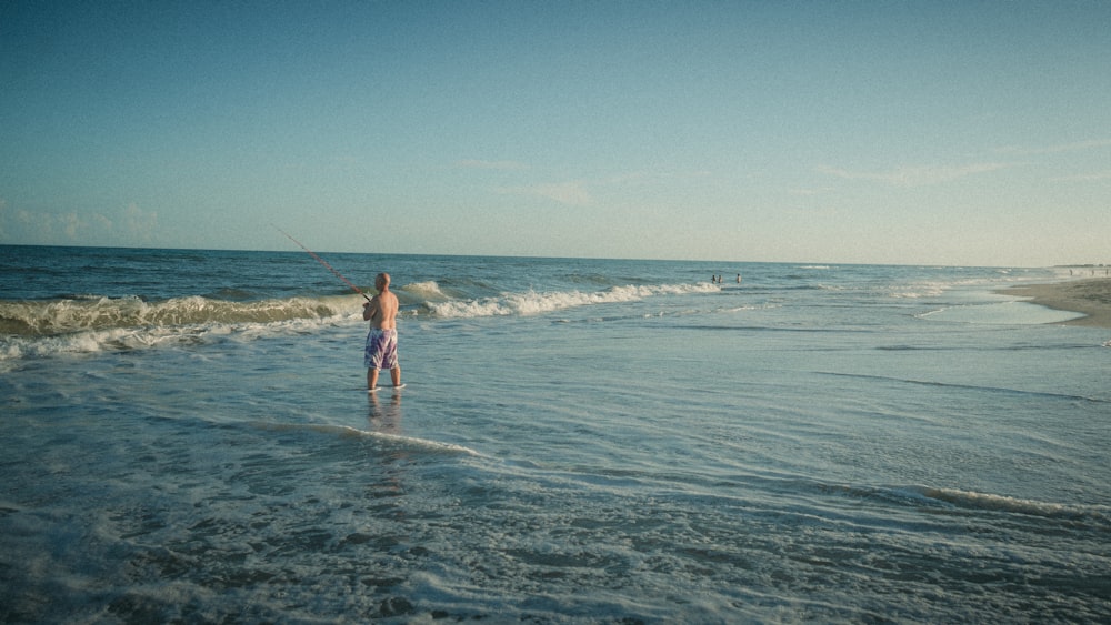 a man fishing in the ocean