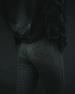 Tailored dark denim pants displayed on a mannequin, highlighting the fabric texture.