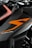 A close-up view of a motorcycle part featuring sleek black and orange design elements. The bodywork showcases the word 'SUPERDUKE' in stylized white text. The logo 'KTM' is also visible, indicating the motorcycle's brand. The image focuses on the angular lines and the modern, aggressive styling of the vehicle.