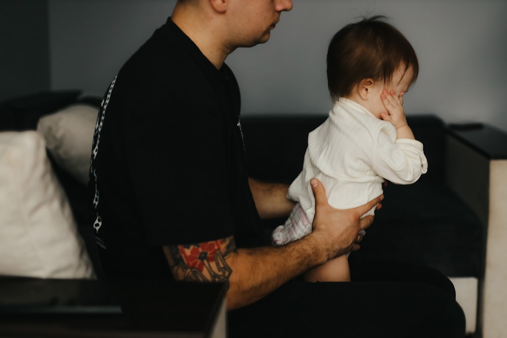 a man holding a baby