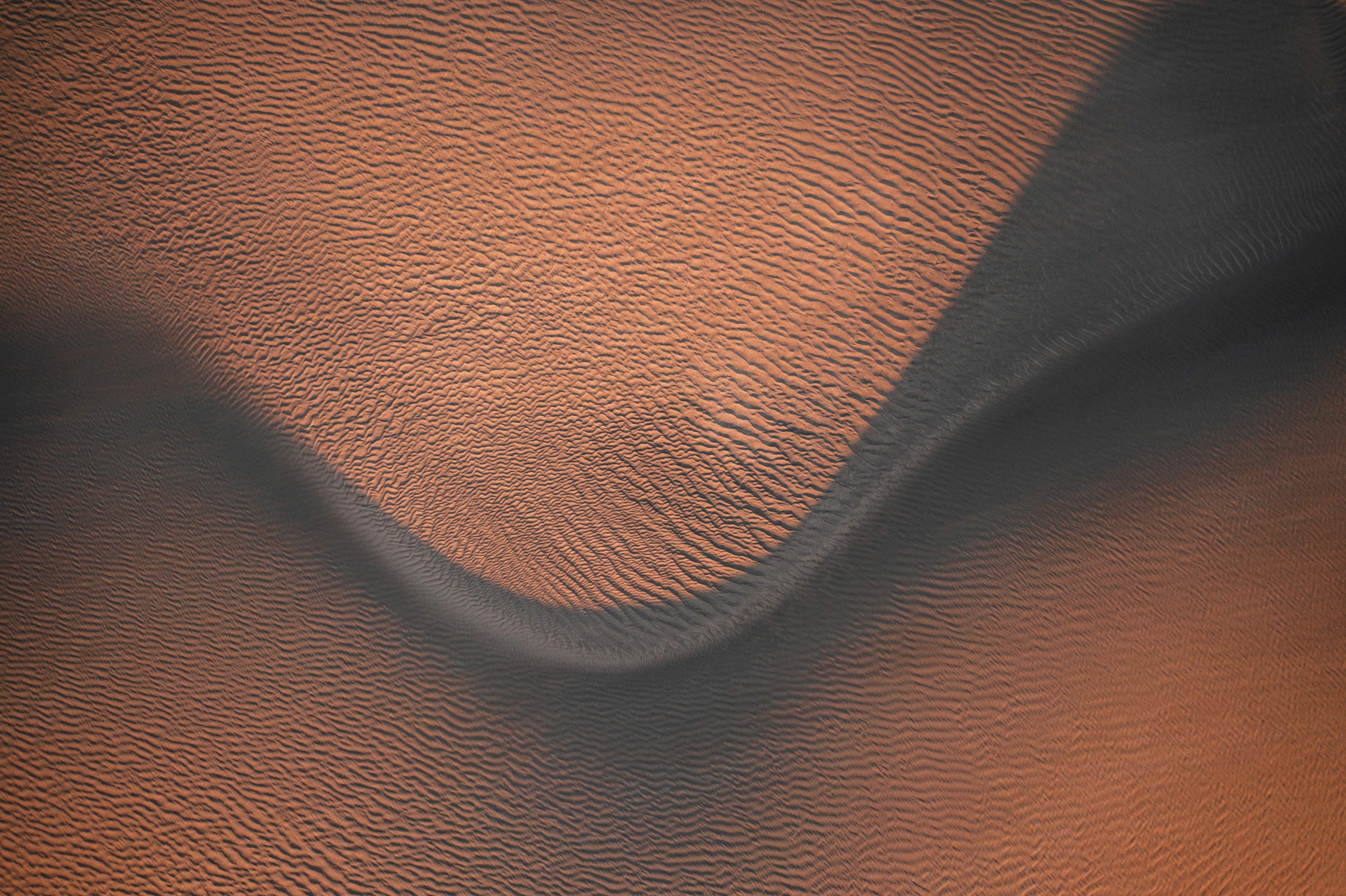 This is a series of aerial texture shots from one of Oregon’s hidden treasures: The Christmas Valley Sand Dunes. I visit at least once a year. The landscape is in constant flux, which you can see in several of these photos with wisps of sand blowing through the air. On this particular trip, the sky had an eerie red glow as smoke drifted into the valley from nearby forest fires. GPS struggles finding this place and will either respond with “wtf I dunno” or tell you to follow nonexistent roads. It took a couple years of exploring but I found some an old network of extremely rough backroads that