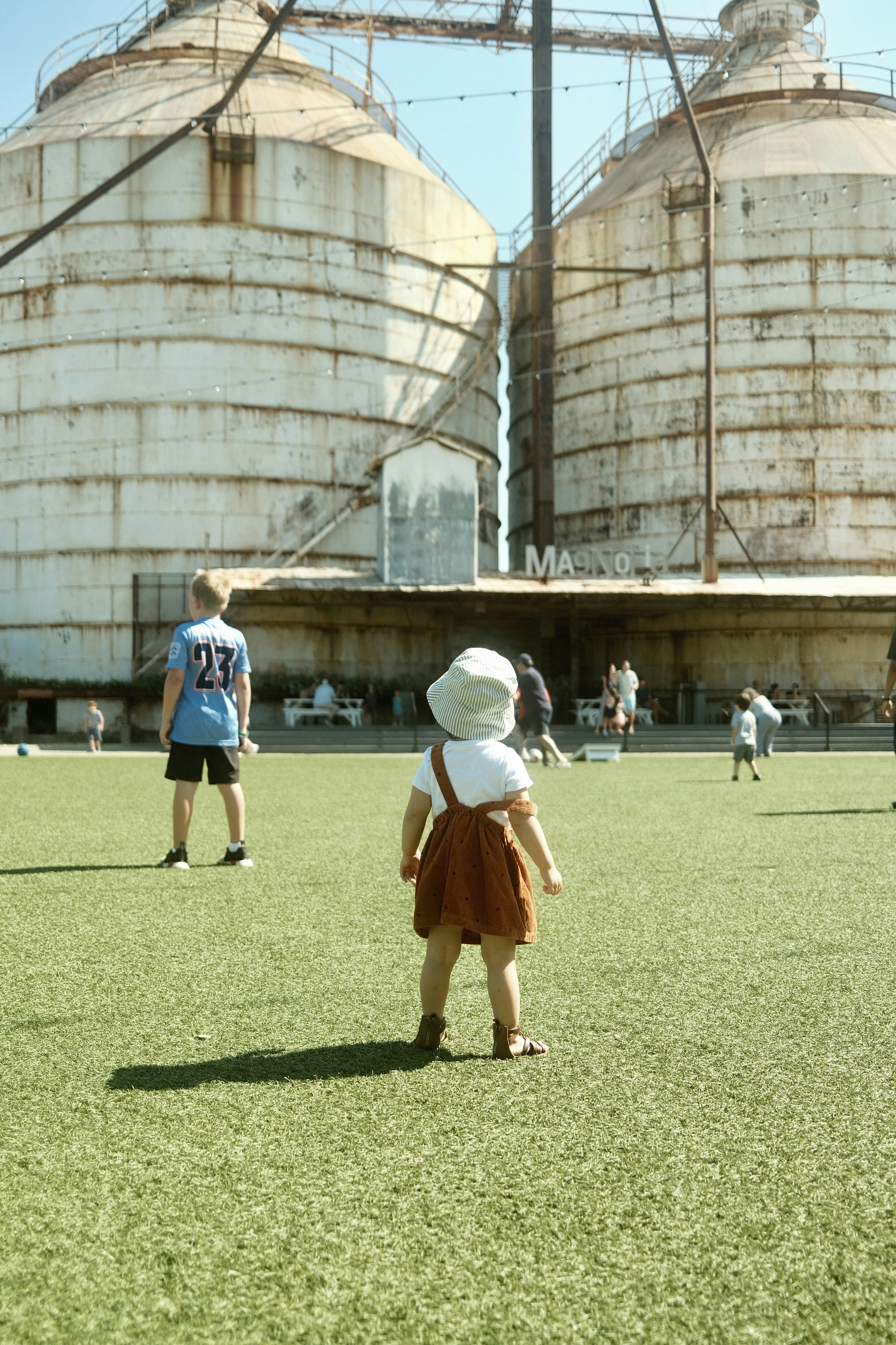 a group of people walking in front of a large structure