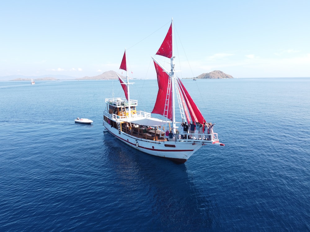 a boat with people on it sailing in the water