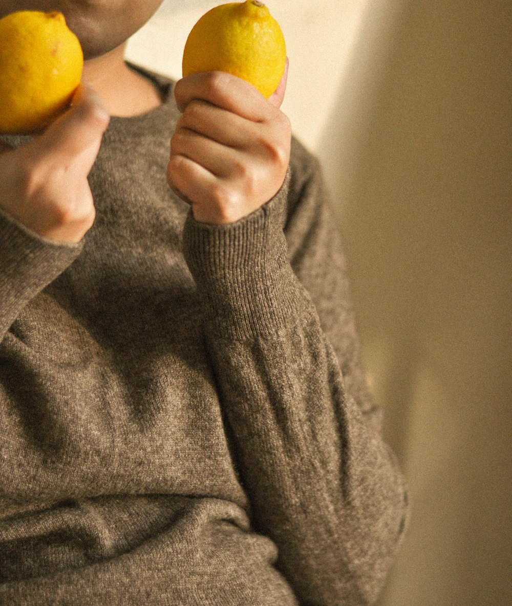 a person holding a lemon