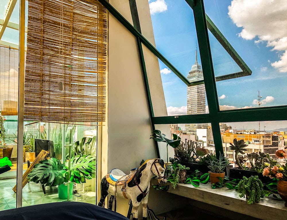 a room with a window and plants