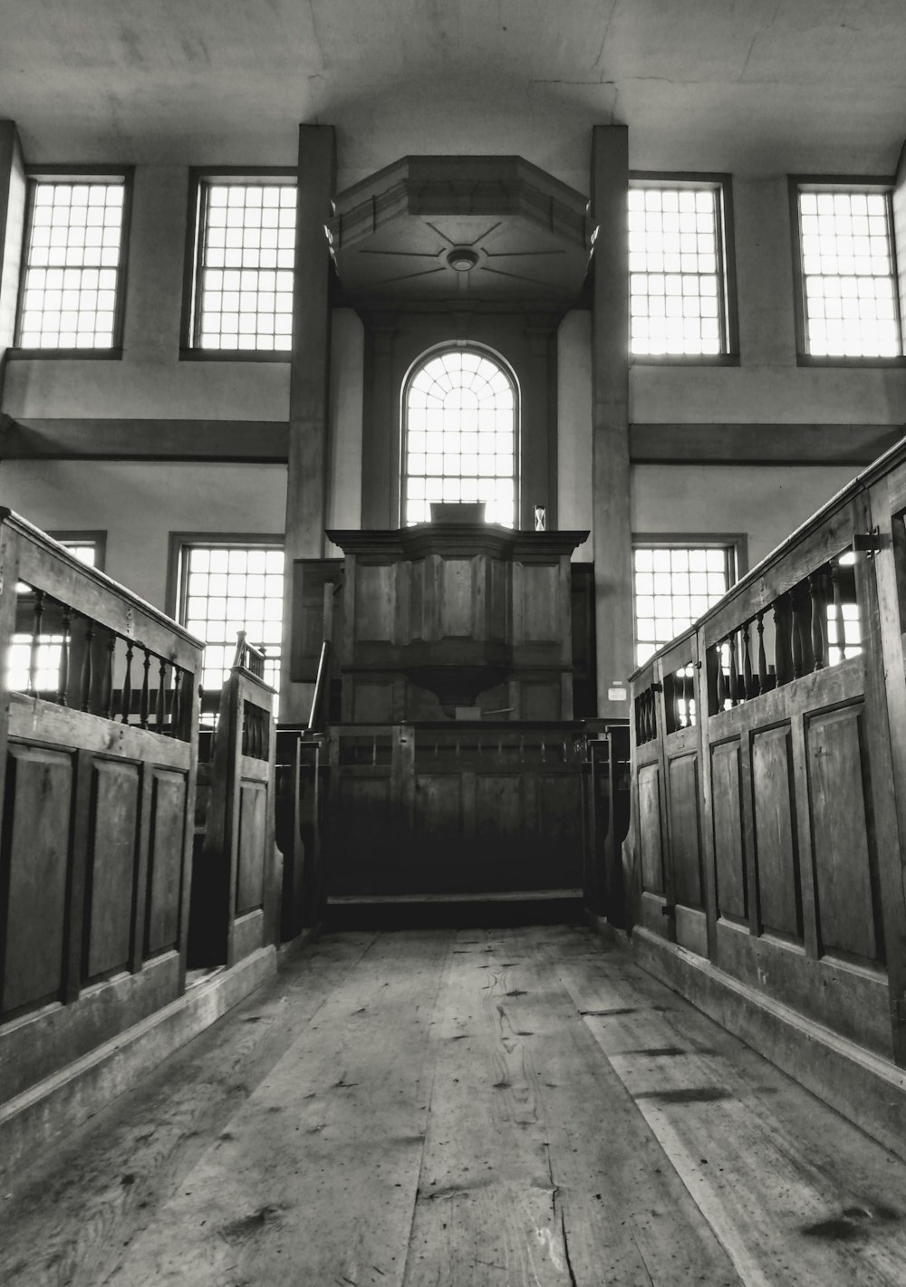 a room with windows and a wood floor