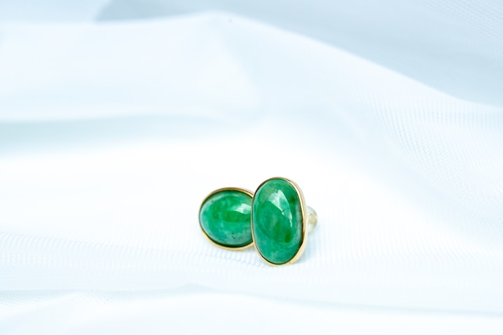 a pair of green and black dice