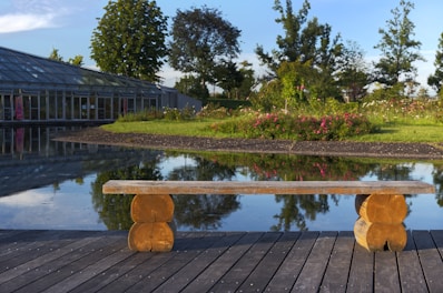 Outdoor wooden bench surrounded by flowers near Golden Pond Resort’s standard rooms.