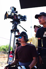 a group of people looking through a camera