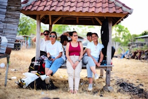 a group of people sitting on a bench