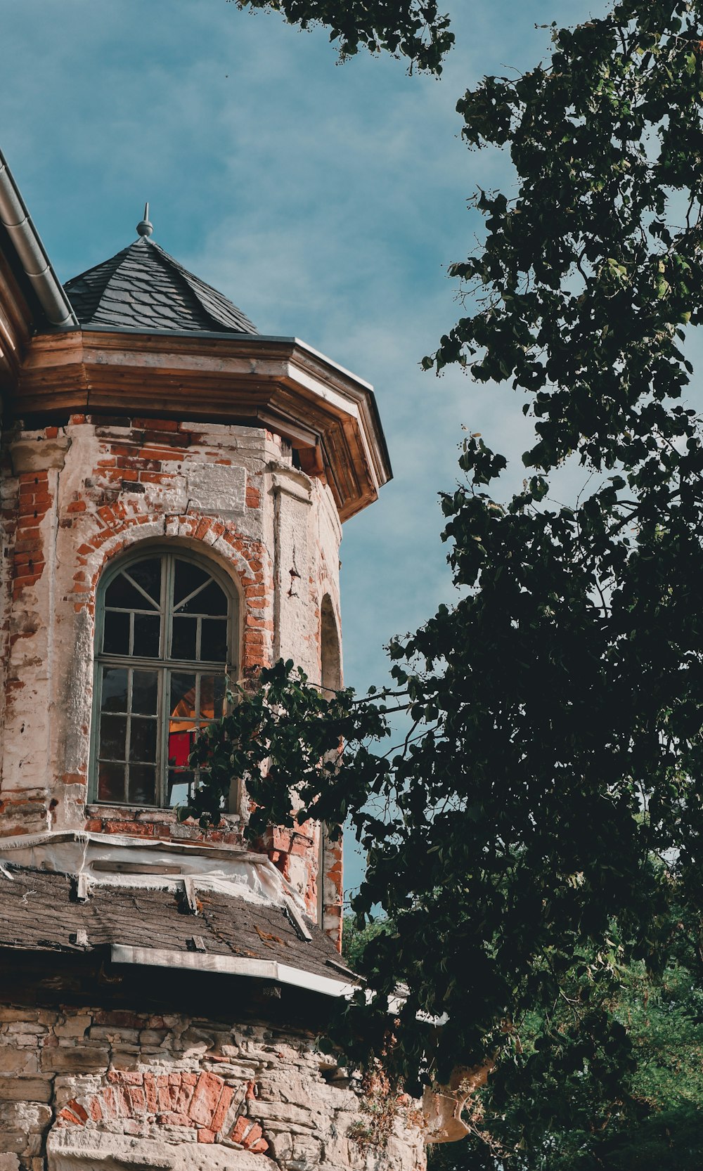 a brick building with a tree in front of it