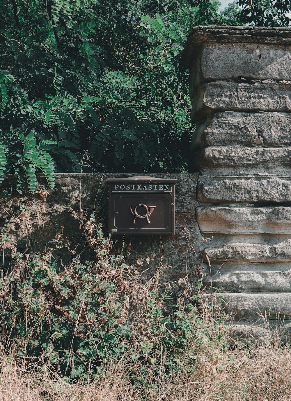 a sign on a stone wall