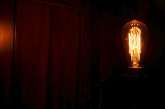 A sleek smart LED bulb glowing warmly in a modern living room