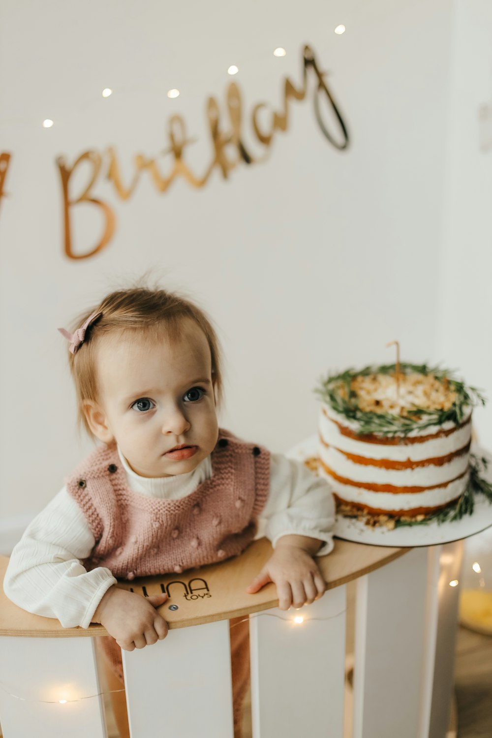 a baby holding a cake