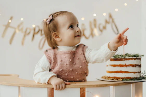 a girl holding a cake