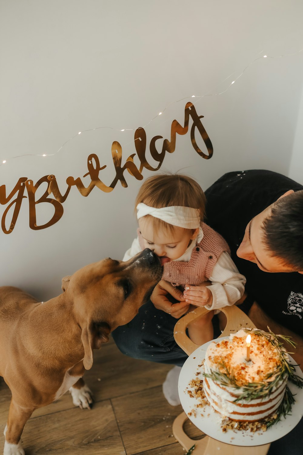 a person and a child looking at a dog