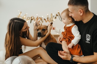 a man and woman holding a dog