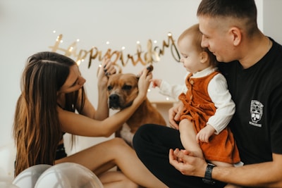 a man and woman holding a dog