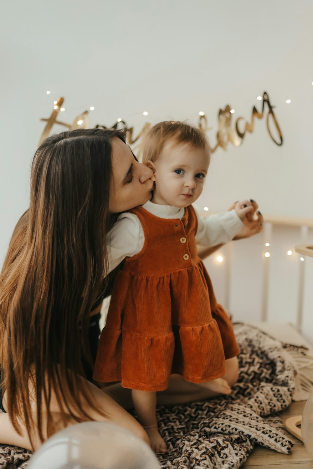 a person kissing a baby