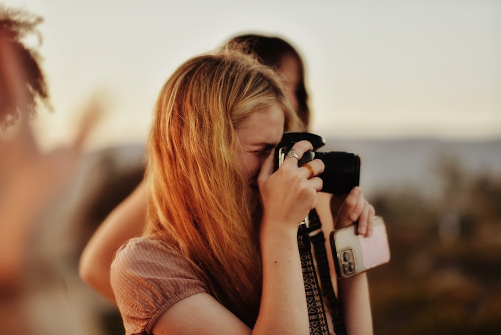 a woman holding a camera